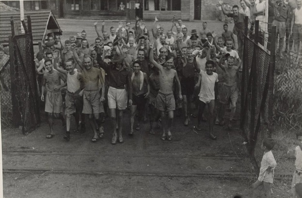 Ex-PoWs Exit Prison Gates Waving and Smiling 